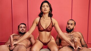 Two guys fuck a girl while their hands are tied in sync, moaning together
