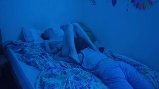 A couple has sex under the neon lights, enjoying every moment